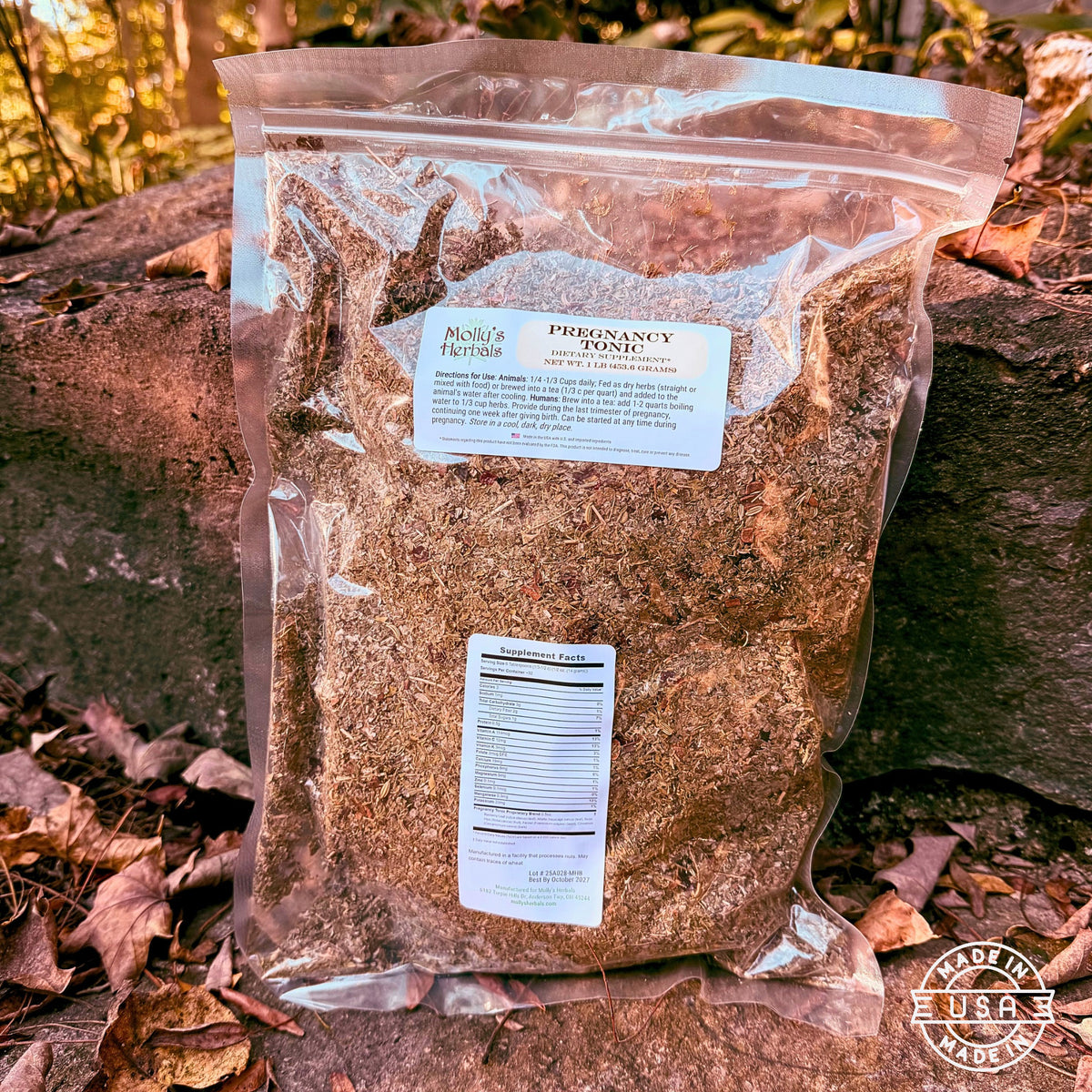 Pregnancy tonic bagged herbs in clear pouch on stones. Made in USA label bottom right